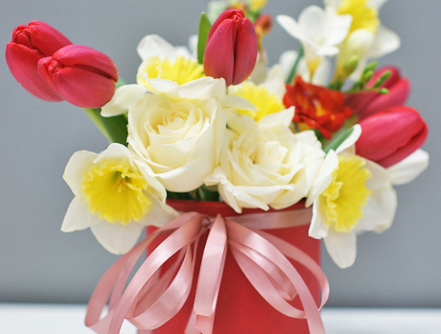 Box with red tulips and daffodils photo